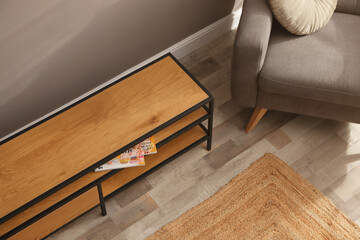 Sticker - Wooden cabinet and comfortable armchair near grey wall in room, above view