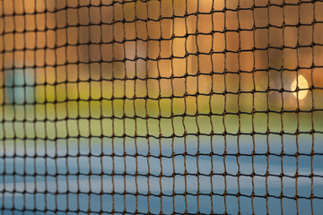 Late afternoon close up tennis court net