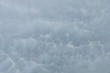 A Wide Patch Of Sky Strewn With Storm Clouds In The Shape Of Bubbles.