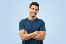 Attractive Smiling Handsome Man In Blue T-shirt Standing With Crossed Arms