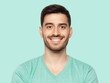 Portrait of young handsome smiling man, wearing casual mint blue t-shirt