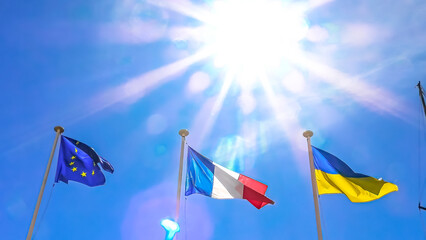 Wall Mural - The Ukraine flag and European flag with France flag in the sun united in support of the Ukraine joining the European Union. isolated on blue sky background.