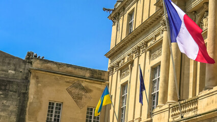 Wall Mural - The Ukraine flag and European flag with France flag at the window waving united in support of the invasion of Ukraine and its joining the European Union. Europeans support Ukraine joining the EU.