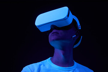 Wall Mural - man interting with virtual reality using vr headset.