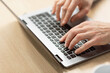 © Prostock-studio - Business man using laptop sitting at desk in office