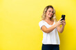 © luismolinero - Young Brazilian woman isolated on yellow background making a selfie
