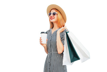 Wall Mural - Portrait of happy smiling young woman with shopping bags wearing summer straw round hat, black white striped dress isolated on white background