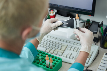 Wall Mural - Female specialist scanning blood samples in laboratory