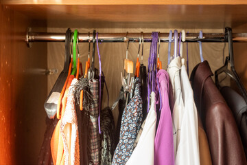 women's dresses on hangers in the wooden closet