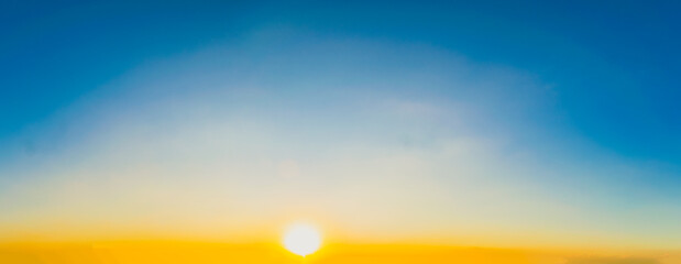 Wall Mural - Sky blue and orange light of the sun through the clouds in the sky
