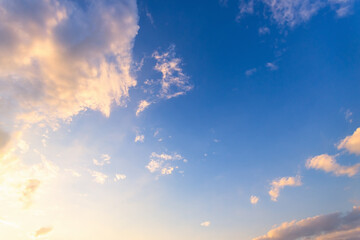 Wall Mural - Sky blue and orange light of the sun through the clouds in the sky
