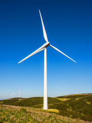 Wall Mural - wind turbines on a beautiful blue sky in a mountain wind farm in sardinia. renewable energy concept,