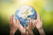 © Proxima Studio - Earth globe in family hands. World environment day. Elements of this image furnished by NASA