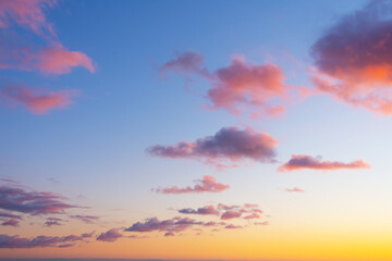 Wall Mural - Colorful individual clouds in the sky at sunset. Gradient color. Sky texture, abstract nature background.
