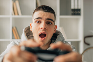 Wall Mural - young man playing with video game controller