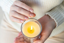 Heat From A Candle On A Woman's Palm.