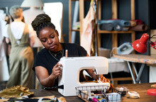 Young Serious Black Woman In Casualwear Sewing New Fashionable Attire For Clients Of Her Boutique Or Creating Seasonal Collection Of Clothes