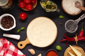 Canvas Print - Pizza and dough homemade cooking with ingredients on table. Pizza with sauce at tabletop