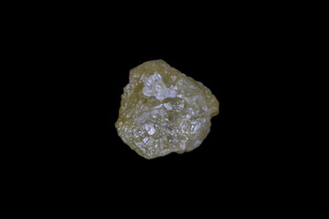 Raw, uncut yellow diamond. 5.7mm diameter, weight 1.9 carats. On Black background. 
