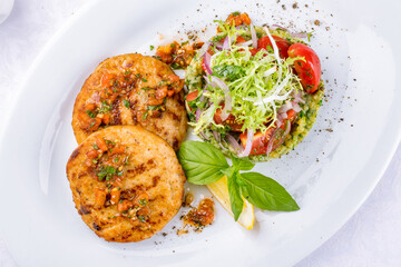 Canvas Print - fish cutlets with pike perch and salmon on a white plate macro close up top view