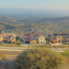 Wall Mural - Square Puffy clouds at sunset Panoramic high view of San Marcos community at San Diego, California