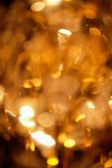 Sticker - Blurred golden background and glittering light.