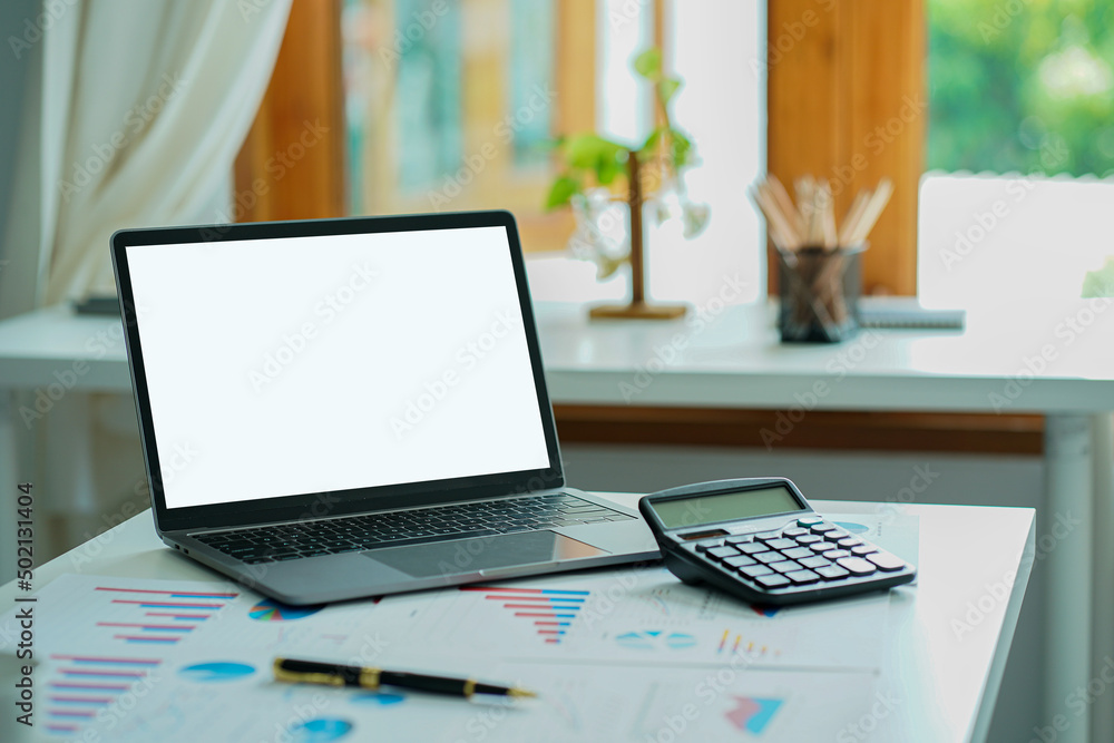 Business ideas, documents, financial graphs, and laptop computers with calculators on the desk.