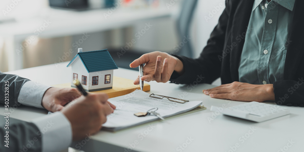 Close up Business woman or Real Estate agent explain signing agreement ...