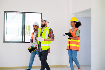 Wall Mural - In doors. Professional Mechanical Engineer team wearing safety hard hat helmet working in  manufacturing factory under construction site.