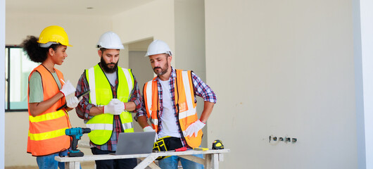 Wall Mural - In doors. Professional Mechanical Engineer team wearing safety hard hat helmet working in  manufacturing factory under construction site.