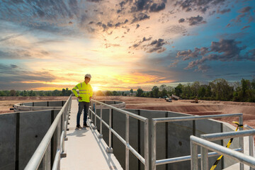 Civil Engineer inspects the construction of a large sewage-water treatment pipe unfinished