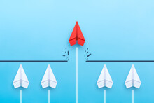 Red Paper Plane Breaking Through Obstacle On Blue Background, Concept Of Overcoming Barriers, Goal, Target