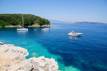 Wall Mural - Corfu island, Greece, beautiful bay with boats. Picturesque greek seascape. Yachting, travel, vacations, summer fun, enjoying life and active lifestyle concept