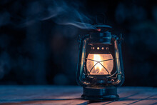 Antique Kerosene Lamp With Lights On The Wooden Floor On The Lawn At Night