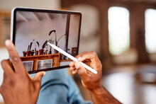 Mature Man Using Tablet PC With Digitized Pen At Home