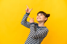Little Caucasian Girl Isolated On Yellow Background Pointing With The Index Finger A Great Idea