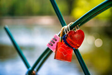 Love Locks Hanging On Fence With Lake In Background