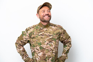 Military man isolated on white background posing with arms at hip and smiling