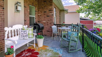 Sticker - Panorama Lounge chairs on a stone tiled deck of a house with bricks