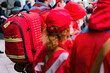 A crowd of emergency medic assistants in red uniforms with backpacks stands outdoor. Trauma. Healthy. Lifeguard. Rapid. Working. Support. Suit. Positive. Problem. Staff. Professional. Physician. Many