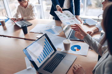 Wall Mural - close up of business people consider documents with charts in a modern office. teamwork concept