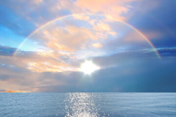 Wall Mural - rainbow at sea blue sky with pink clouds and turquoise sky pastel color summer beach holiday