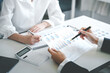 © Daenin - Teamwork with price chart analyzes business people on the table at the conference room.