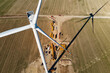 © Lazy_Bear - Installing new wind generator, Windmill turbine maintenance, Construction site with cranes for assembling windmill tower, Wind power and renewable energy