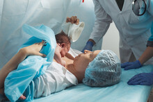 Mother Look To Her Newborn Baby In Hospital