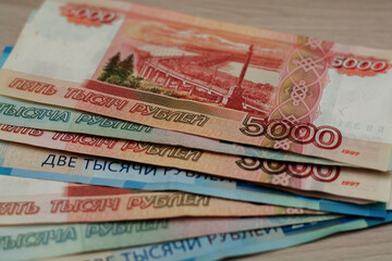 Close-up Russian Ruble money banknotes on a wooden desk - financial, loan and investment concepts.
Horizontal view.