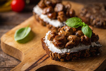Whole Grain Rye Bread Toast With Cream Cheese Or Ricotta, Mushroom And Herbs On Rustic Wooden Background.