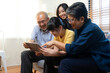 © bennnn - Smiling Asian grandparents on couch with granddaughter looking at tablet. happy three generation family spending time together at home.