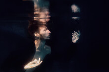 An Underwater Shot Of A Man Screaming In A Swimming Pool On Black Background