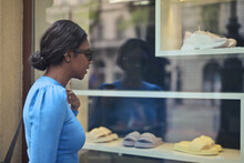 Young Woman In Front Of A Shop Window